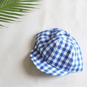 Detail of blue and white gingham cotton baby hat with soft brim and breathable top vents