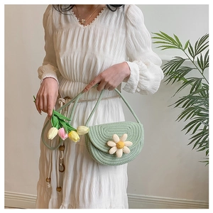 Close-up of green cotton woven bag with a white daisy floral applique and strap detail