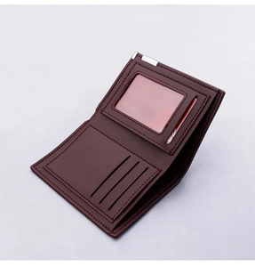 Detail of dark brown leather bifold wallet featuring multiple card slots and silver clip
