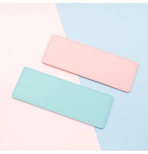 Macro detail of slim pink and mint leather card holders with fine stitching work