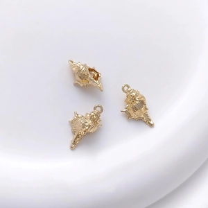 Three 14K gold plated conch shell pendants for DIY jewelry making on white background