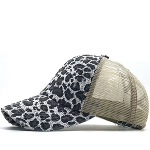 Detail of leopard print trucker hat featuring mesh back and distressed frayed brim edges
