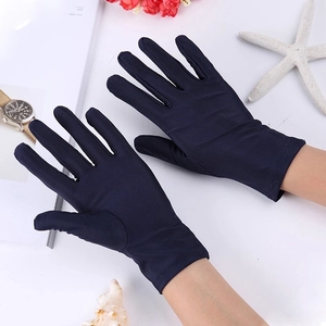 Close-up of navy blue spandex gloves with elastic wrist detail on a white background