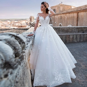 Elegant white lace long sleeve wedding dress with V-neck and luxury ball gown train