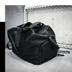 Macro detail of waterproof black sports duffel bag with side pocket and matte metal hardware