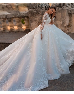 Close-up of luxury white lace embroidery and vine patterns on the long sleeve bridal gown