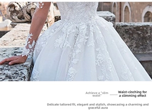 Detailed view of floral lace embroidery and sheer tulle sleeves on white wedding gown