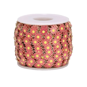 Detail of pink and yellow daisy flower 10mm stainless steel DIY jewelry chain on white spool