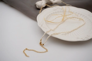 Detail of freshwater pearl necklace with gold lobster clasp and adjustable extension chain
