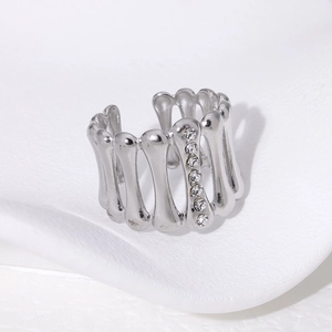 Detailed view of silver bone-shaped adjustable ring with sparkling white rhinestones