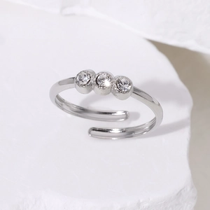 Close-up of adjustable silver steel ring featuring three sparkling round zircons