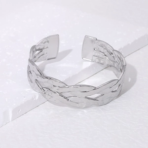 Dettaglio della trama intrecciata argento e motivo martellato sul bracciale