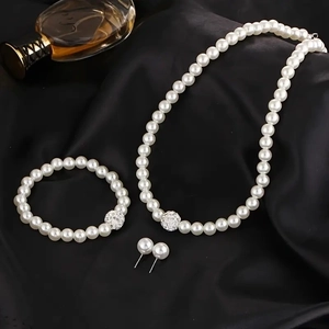Elegant 3-piece faux pearl jewelry set with sparkling silver accents on black silk