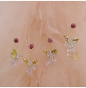Set of four clear acrylic Christmas angels with gold wings and purple pom-poms on tulle