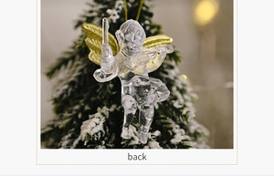 Detailed back view of transparent Christmas angel ornament with gold wings on snowy tree