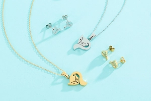 Detail view of gold and silver hollow fox pendant necklaces and matching stud earring sets