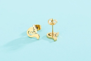 Detailed close-up of cute hollow fox earrings in a polished golden stainless steel finish