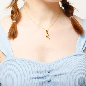 Elegant gold flamingo pendant necklace set worn by a model for a minimalist fashion look