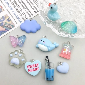 Assorted cute resin cartoon pendants including whale and shell with metal hanging loops