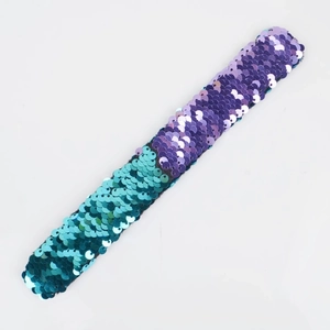 Detail view of two-tone purple and teal sequin slap bracelet for kids' party favors