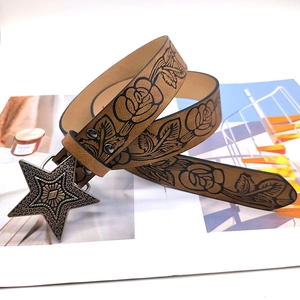 Vintage brown leather belt with embossed roses and a metallic star-shaped buckle