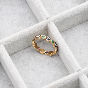 Gold evil eye ring with multi-colored crystals and stones on a velvet jewelry box