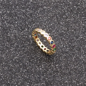 Macro shot of gold eternity ring with colorful round-cut gemstones in rainbow pattern