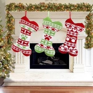 Close-up of knitted bone-shaped Christmas stockings hanging on a festive decorated fireplace