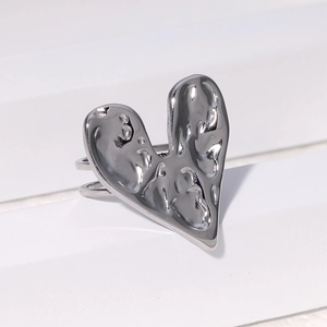 Detailed view of silver heart-shaped ring with unique liquid lava texture and dual-layer band