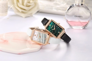 Detail of square quartz watches with malachite texture dials and leather straps