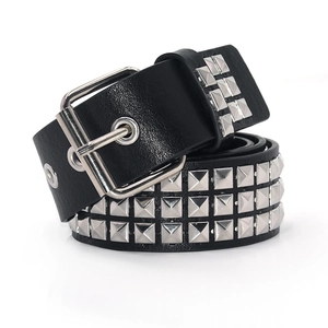 Detail of a black punk leather belt with triple row silver pyramid studs and metal buckle