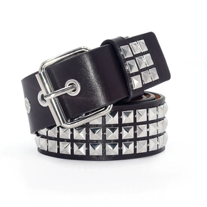 Close-up of black leather punk belt featuring triple rows of square metal pyramid studs