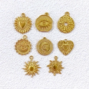 Eight golden stainless steel punk charms including heart sun moon and evil eye for DIY jewelry