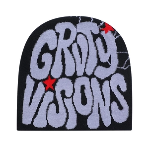 Close-up of knit texture on black beanie with purple lettering and red star detail
