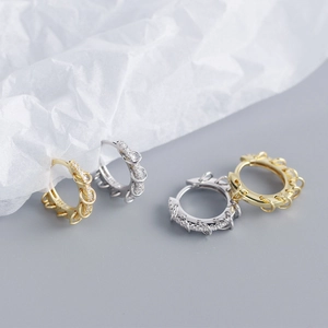 Macro detail of S925 sterling silver hoop earrings with micro-set stones and chain texture