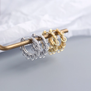 Detail of S925 sterling silver hoop earrings with pave cubic zirconia and dangling rings
