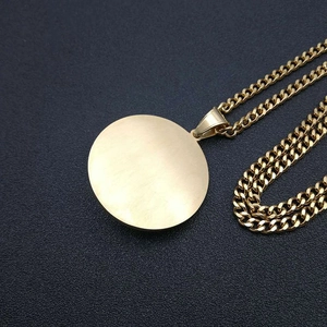 Detailed close-up of a gold-plated titanium lion head pendant on a thick rope chain