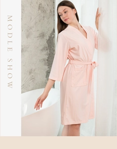 Detail view of light pink waffle robe featuring V-neck design and soft fabric texture
