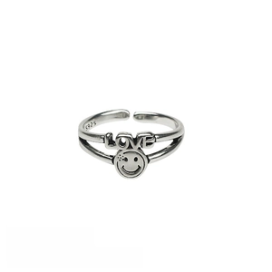 Detail of adjustable silver alloy ring featuring LOVE text, smiley face, and S925 stamp