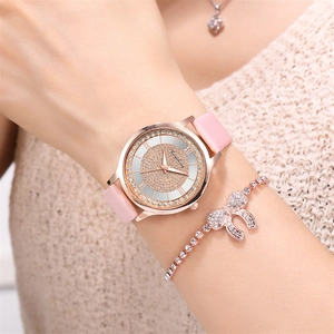 Detailed view of pink leather watch with rhinestone dial and matching rose gold bracelet