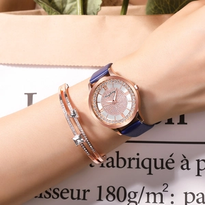 Detail of rose gold starry watch set with leather strap and zircon bracelets on wrist