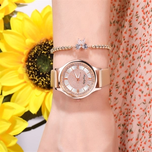 Close-up of rose gold starry dial watch with matching butterfly bracelet on wrist