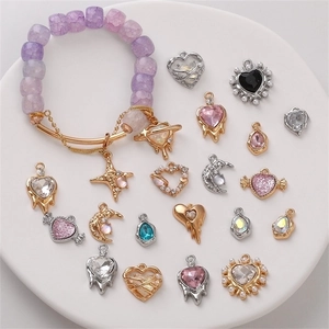 Detail of DIY jewelry set with purple beaded bracelet and various rhinestone pendants