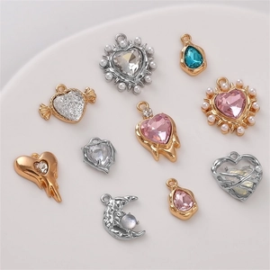 Detail shot of ten diverse gold and silver alloy jewelry charms with colorful rhinestones