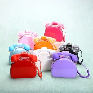 Collection of creative retro telephone handbags in multiple bright colors with spiral straps