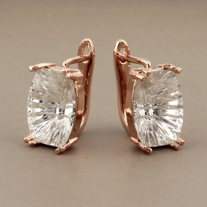 Detail of rose gold lever-back earrings with large rectangular cut sparkling crystals