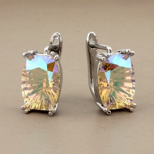 Macro shot of mystic topaz earrings with rainbow crystals in silver prong settings