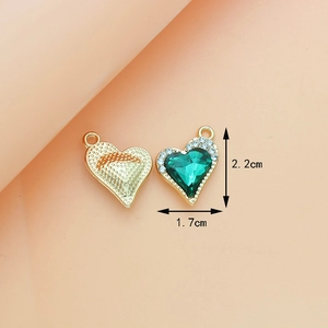 Detailed view of green heart pendant with gold base and size markings 2.2cm x 1.7cm