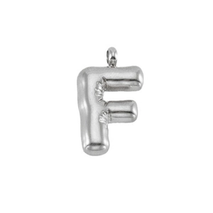 Macro view of polished silver bubble letter F pendant with smooth metallic texture