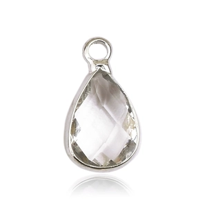 Macro shot of a teardrop-shaped glass birthstone pendant in a silver metal frame